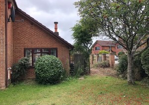 Exterior of new pitched-roof brick extension to Poole detached house.