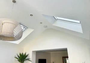 Bright interior of Romsey home extension with modern glazing and pendant lighting.