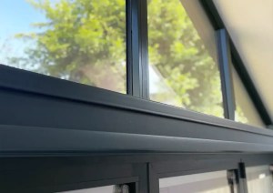 Powder coated anthracite aluminium window and roof glazing detail in Romsey home extension.