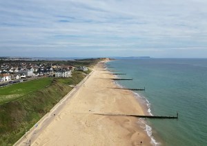 Aerial view of Southbourne beach and coastline in Dorset, showing the sandy shoreline and groynes extending into the sea.