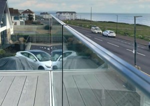 Close-up of glass balcony railing at the Southbourne Coast property.