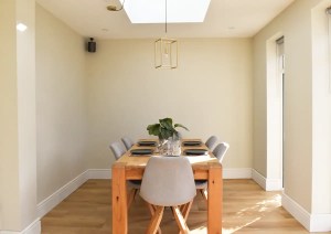 Interior of dining room extension with pitched skylight and glazed doors in Southampton.