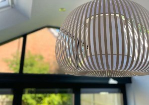 Pendant light fixture hanging in modern sunroom extension interior in Romsey.