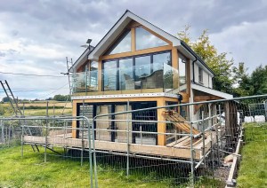 Front view of The Cottage featuring modern glazing and timber detailing.