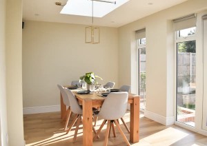 Dining room extension with glazed doors and rooflight bringing natural light into Southampton home.