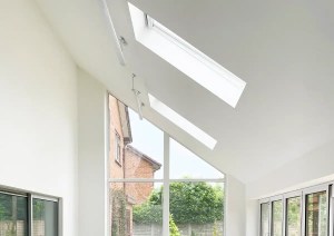 Interior view of pitched glazing gallery extension showing natural light and open-plan space.