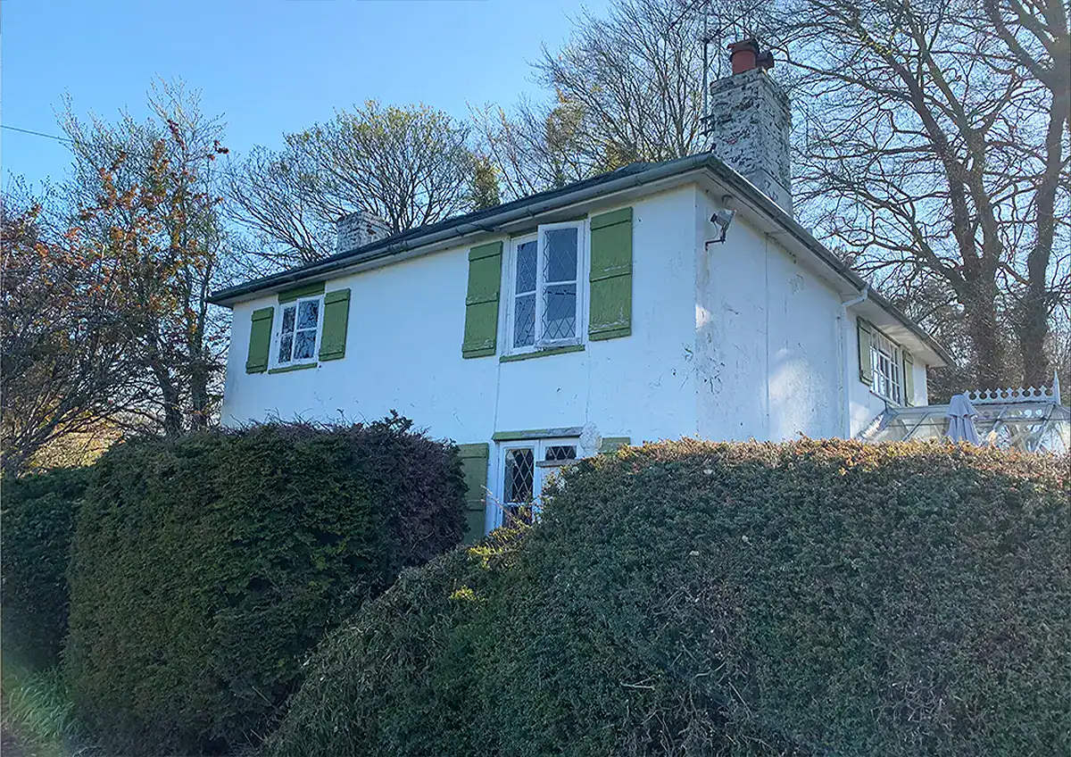 Photographs showing the original cottage on the site prior to new build works.