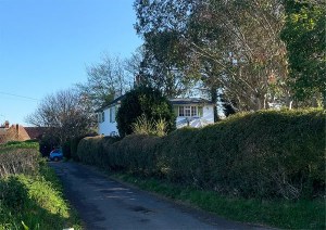 Photographs showing the original cottage on the site prior to new build works.