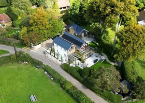 Aerial view of modern roofline and garden layout of a contemporary countryside cottage.