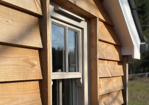 Close-up of timber cladding and window detailing at The Cottage.