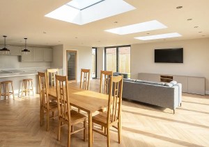 Open plan kitchen dining space with rooflights in Seaview Hampshire extension by Heim Architecture.